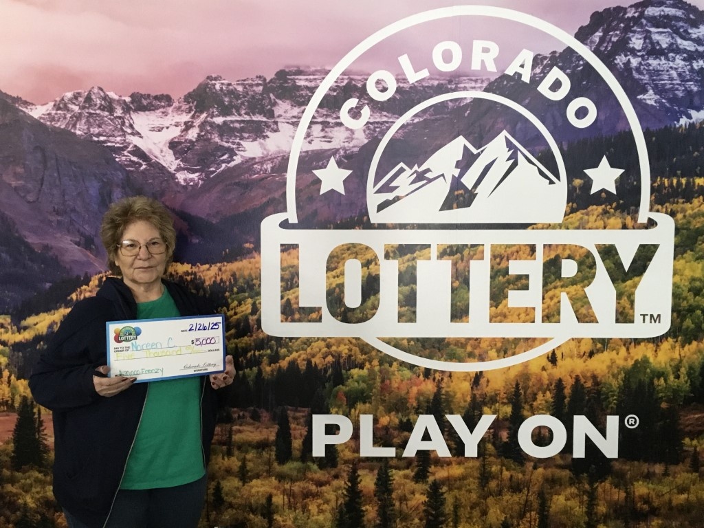 Ganador(a) con cheque de gran tamaño en las oficinas de la Lotería de Colorado