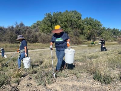 Woman picking up trash at the Runyon to the Res event 2023